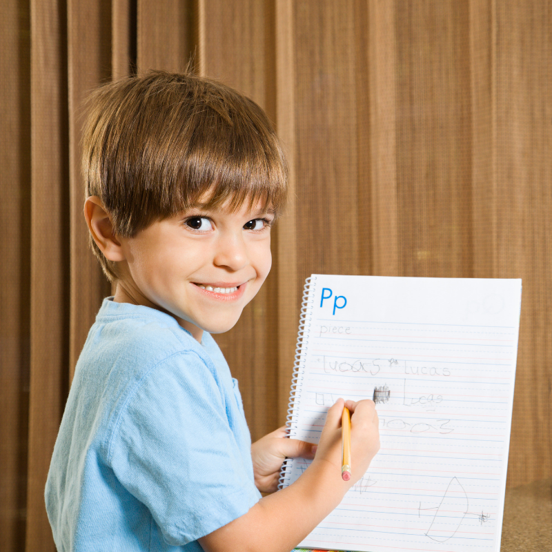 Little boy working on writing